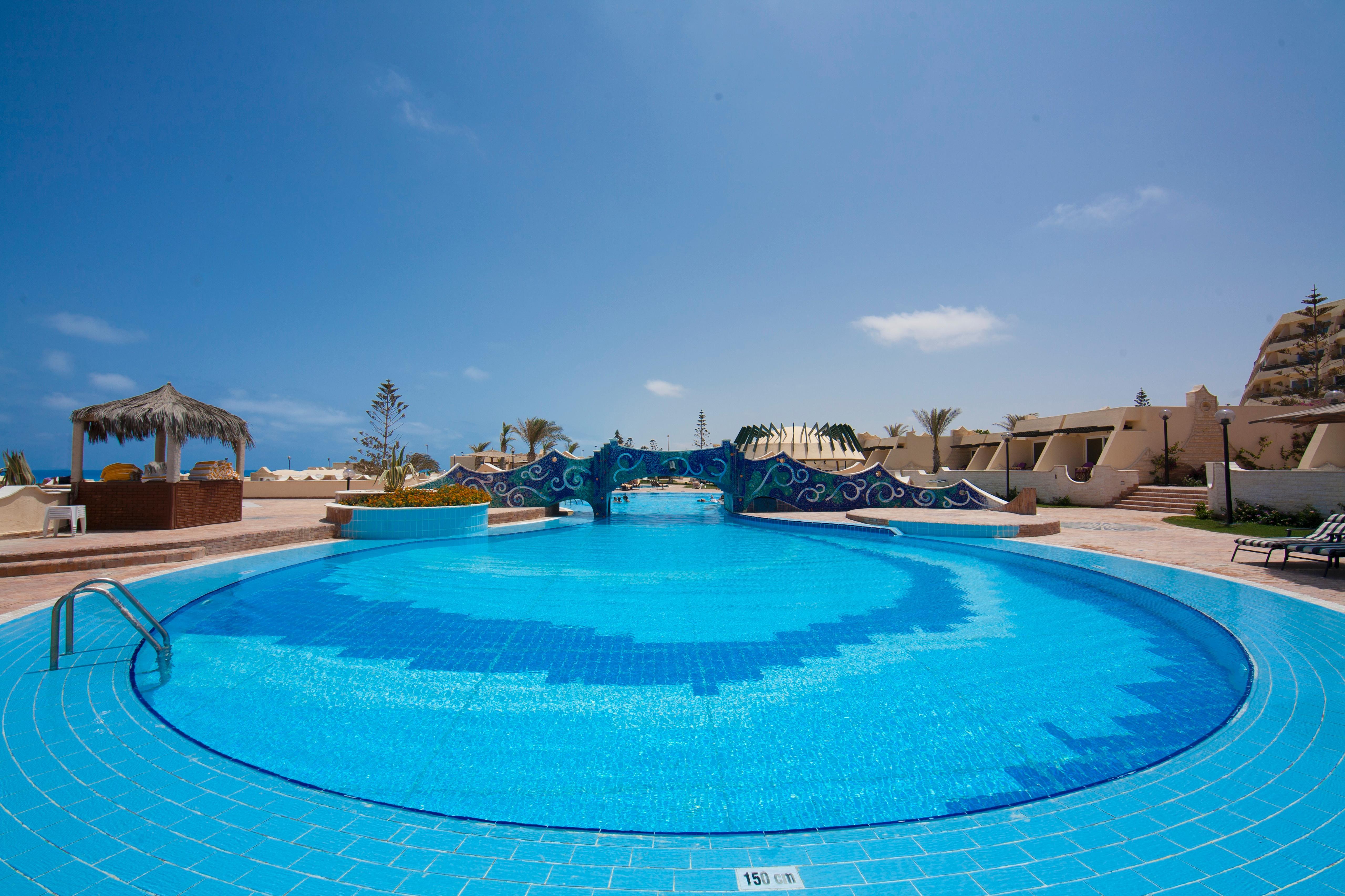Borg El Arab Beach Resort Buitenkant foto A swimming pool at a resort in Egypt